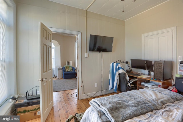 bedroom with baseboards and light wood-type flooring