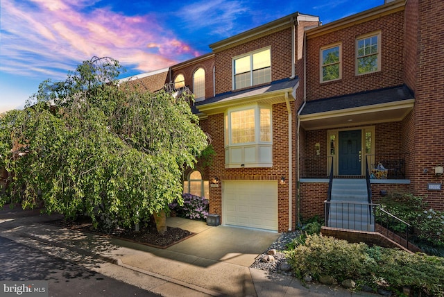 10227 Aspen Willow Dr, Fairfax, VA 22032 - townhome / multi-family property with an attached garage, concrete driveway, and brick siding