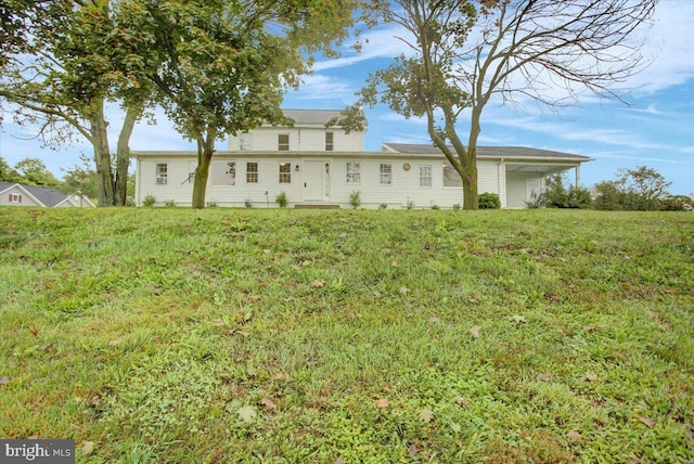 back of property featuring a yard
