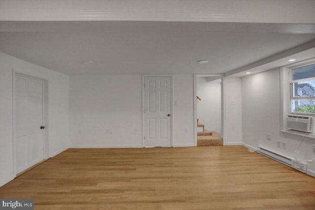 basement with a baseboard heating unit, baseboards, stairway, recessed lighting, and light wood-style flooring