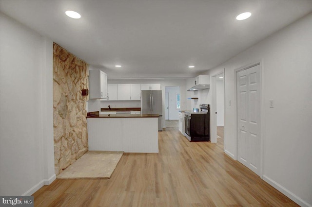 kitchen with under cabinet range hood, white cabinetry, stainless steel appliances, a peninsula, and light wood finished floors