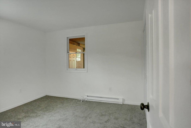 carpeted empty room featuring a baseboard heating unit and baseboards