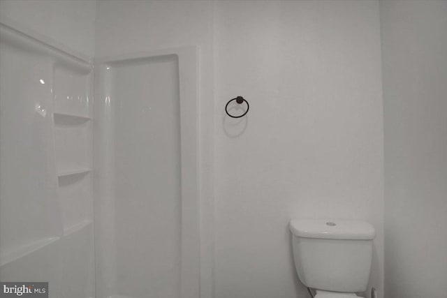 bathroom with toilet and walk in shower