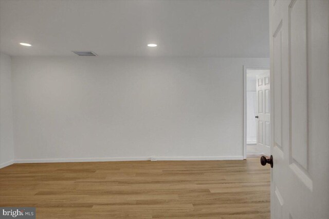 unfurnished room with recessed lighting, light wood-style floors, visible vents, and baseboards