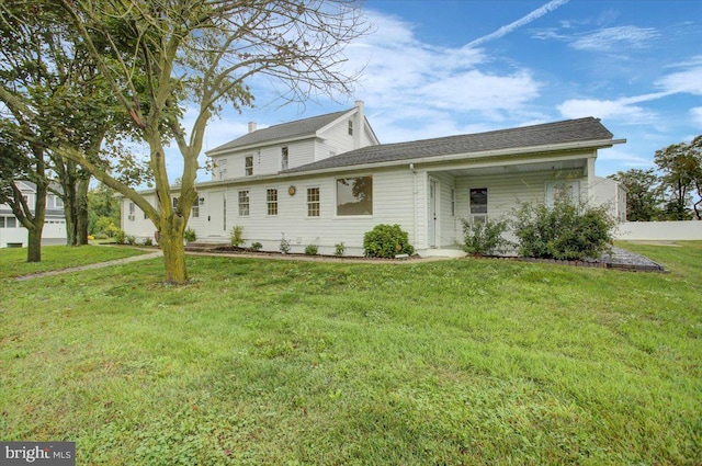 back of property with a yard
