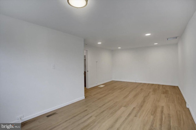 unfurnished room featuring recessed lighting, visible vents, light wood-style flooring, and baseboards