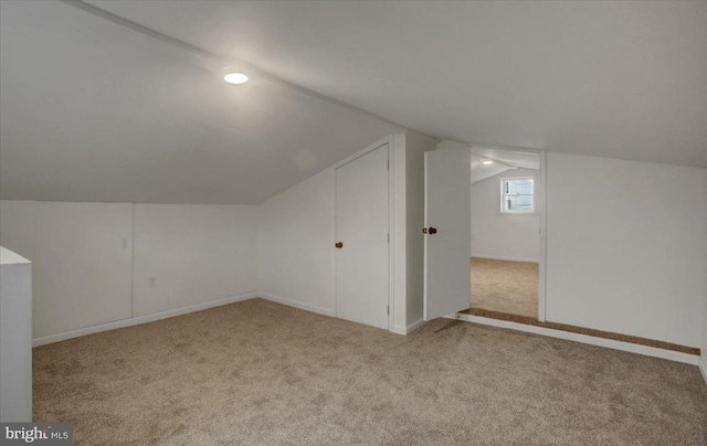 bonus room featuring carpet flooring, baseboards, and vaulted ceiling