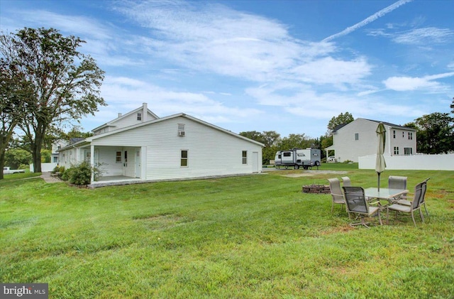 view of yard with a fire pit and a patio