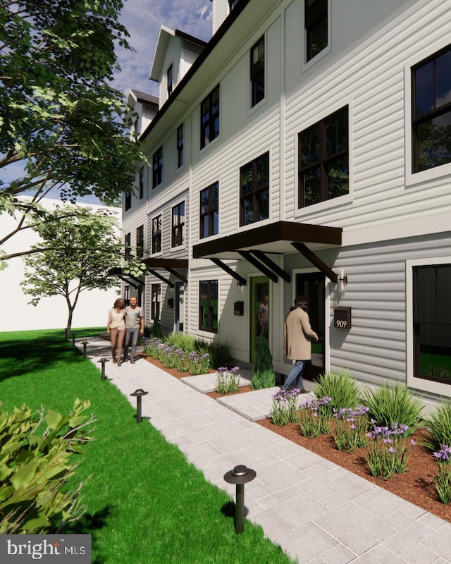 exterior space with a chimney and a front yard