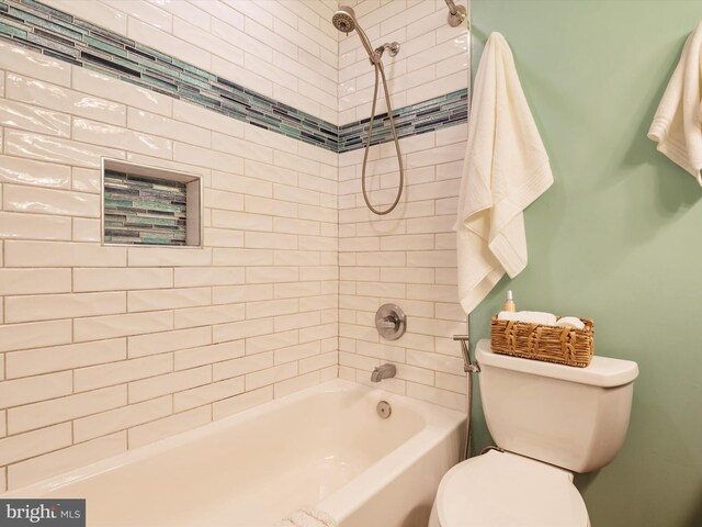 bathroom featuring washtub / shower combination and toilet
