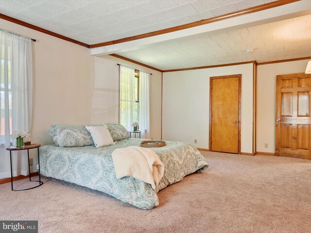 carpeted bedroom with baseboards and ornamental molding