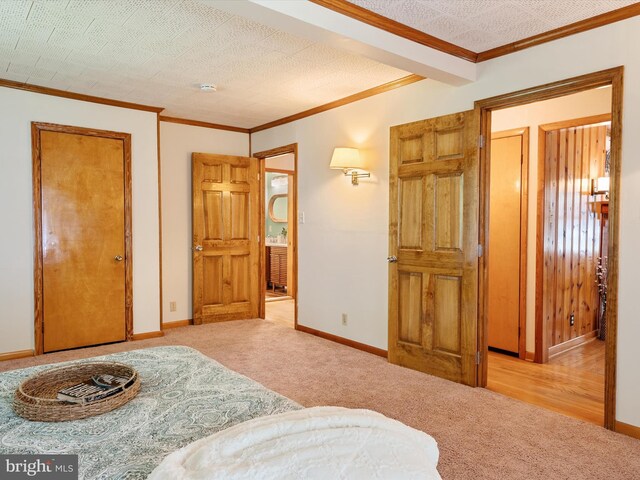 carpeted bedroom with baseboards and ornamental molding