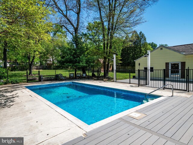 view of swimming pool featuring a fenced in pool, a patio area, and fence