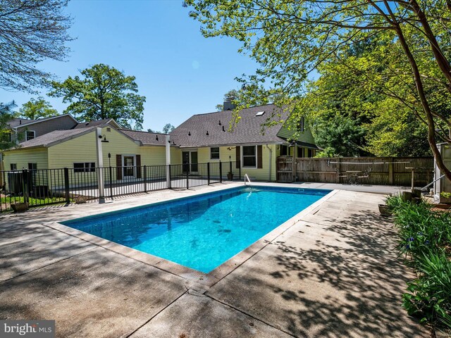 view of swimming pool with a fenced in pool, fence, and a patio