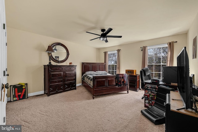 carpeted bedroom with baseboards and ceiling fan