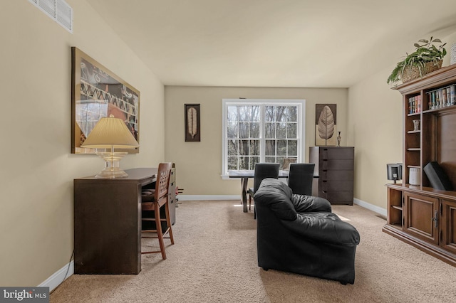 carpeted office with visible vents and baseboards