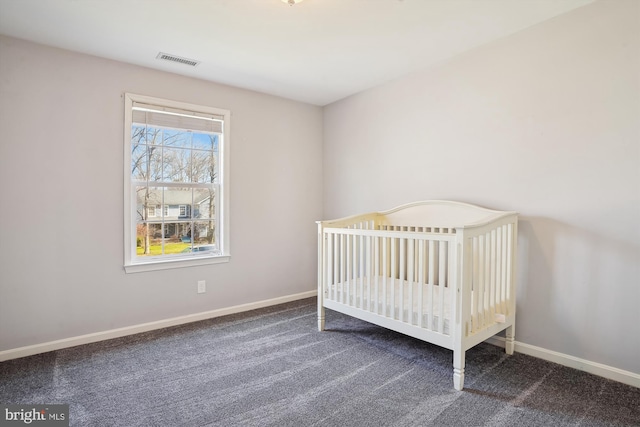 bedroom featuring baseboards, visible vents, and carpet