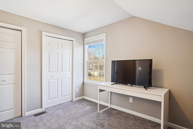 carpeted bedroom with a closet, vaulted ceiling, visible vents, and baseboards