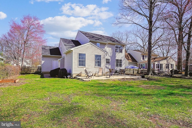 back of house with a lawn, fence, and a patio area