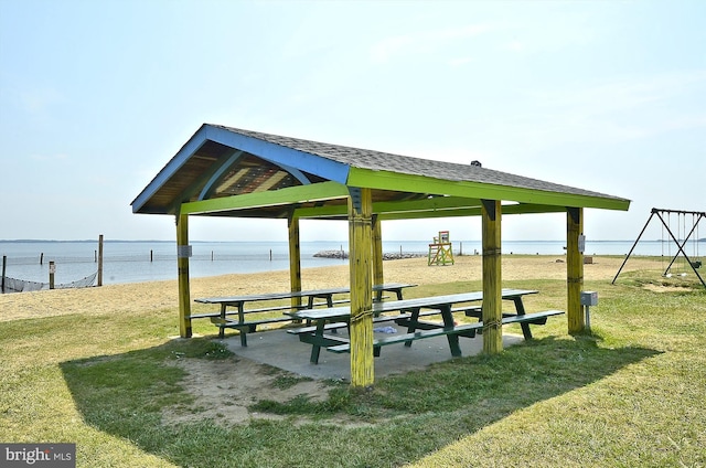 view of community with a gazebo, a yard, and a water view