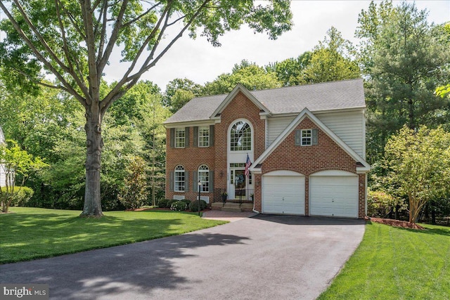 7625 Holbrook Ct, Manassas, VA 20112 - view of front of home featuring asphalt driveway, brick siding, a front yard, a garage, and roof with shingles