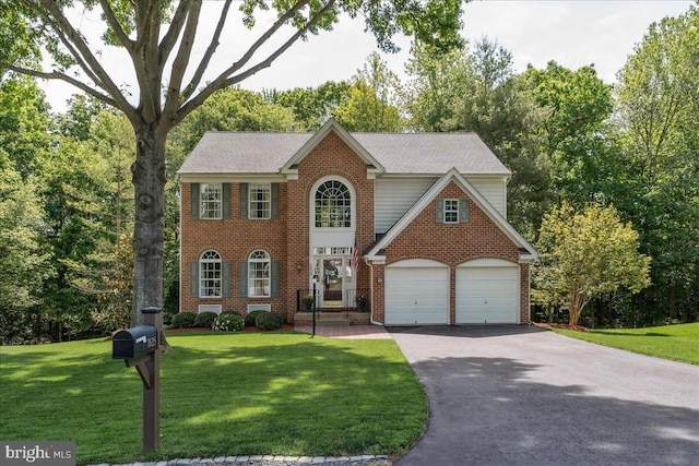 7625 Holbrook Ct, Manassas, VA 20112 - view of front facade with brick siding, driveway, a front lawn, and a garage