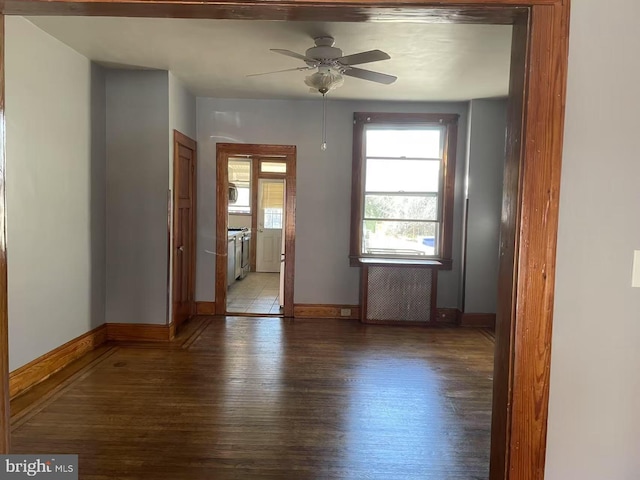 spare room with a ceiling fan, baseboards, and light wood finished floors
