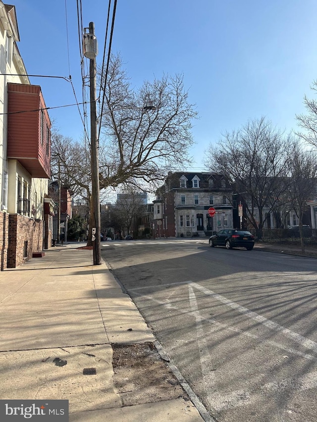 511 N 37th St, Philadelphia, PA 19104 - view of asphalt road featuring traffic signs, curbs, street lighting, and sidewalks