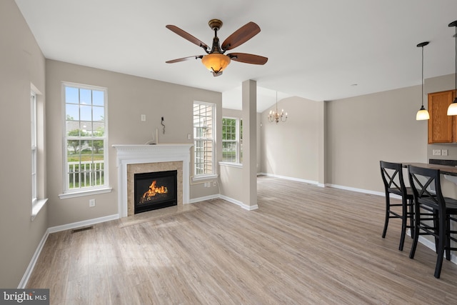 10023 Iron Pointe Drive Ext Unit 201B2, Millsboro, DE 19966 - unfurnished living room with plenty of natural light, light wood-style floors, and a high end fireplace