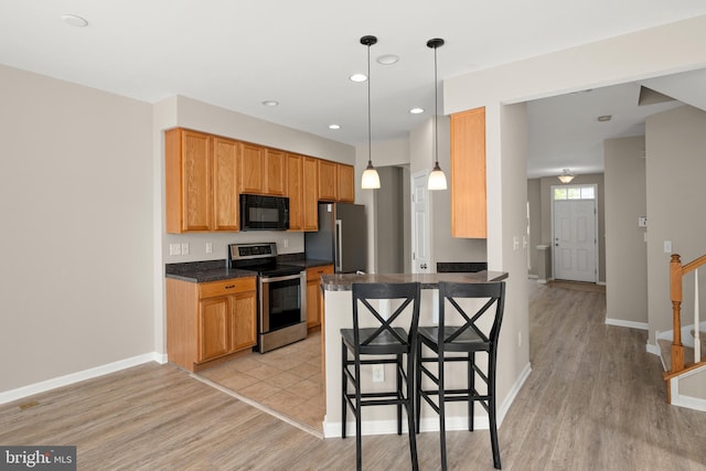 10023 Iron Pointe Drive Ext Unit 201B2, Millsboro, DE 19966 - kitchen featuring appliances with stainless steel finishes, dark countertops, light wood-type flooring, baseboards, and recessed lighting
