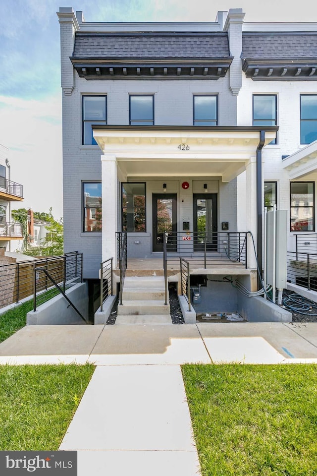 426 Manor Pl NW Unit 3, Washington, DC 20010 - view of front of home featuring brick siding, a porch, and mansard roof