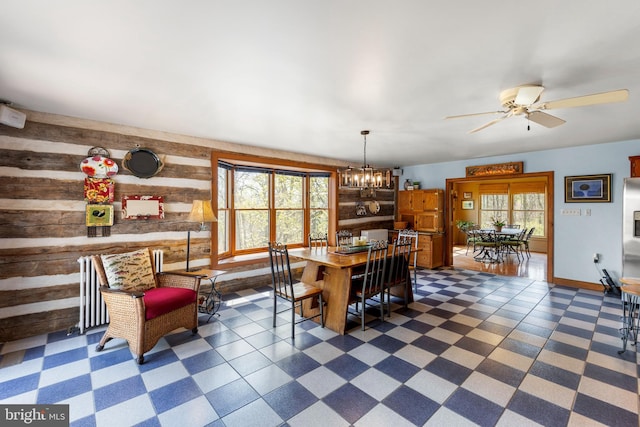 1460 Pitcock Ln, Winchester, VA 22602 - dining space featuring dark floors, wooden walls, and ceiling fan with notable chandelier