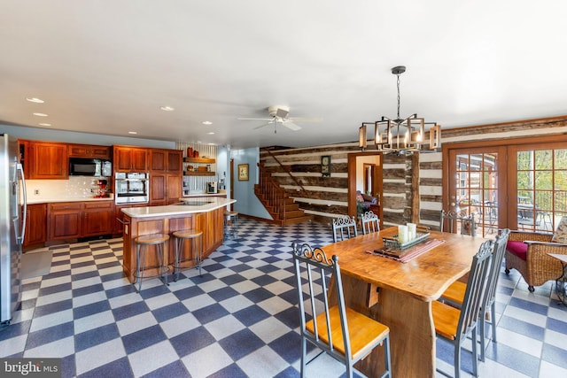 1460 Pitcock Ln, Winchester, VA 22602 - dining room featuring wooden walls, recessed lighting, ceiling fan with notable chandelier, french doors, and dark floors