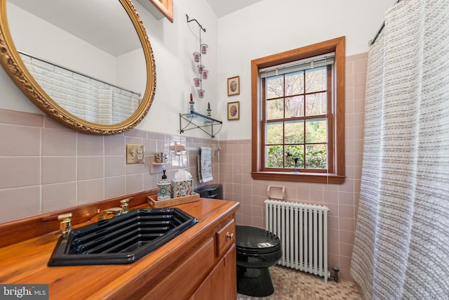1460 Pitcock Ln, Winchester, VA 22602 - bathroom featuring radiator heating unit, vanity, toilet, wainscoting, and tile walls