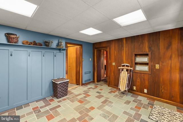 1460 Pitcock Ln, Winchester, VA 22602 - unfurnished room with radiator heating unit, wood walls, baseboards, and a drop ceiling