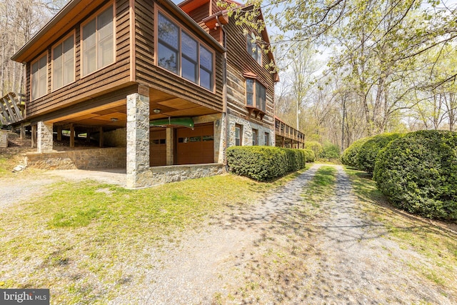 1460 Pitcock Ln, Winchester, VA 22602 - view of home's exterior featuring a carport, driveway, and stone siding