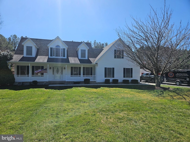 cape cod home with a front yard and covered porch