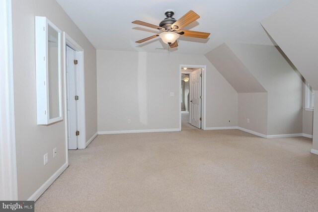 additional living space with baseboards, carpet floors, lofted ceiling, and a ceiling fan