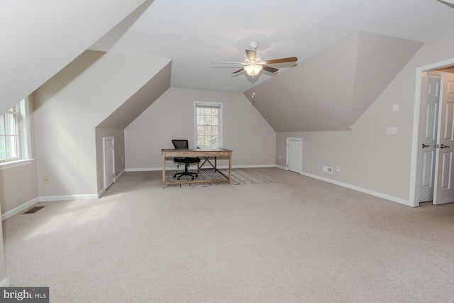 unfurnished office featuring visible vents, lofted ceiling, ceiling fan, and carpet