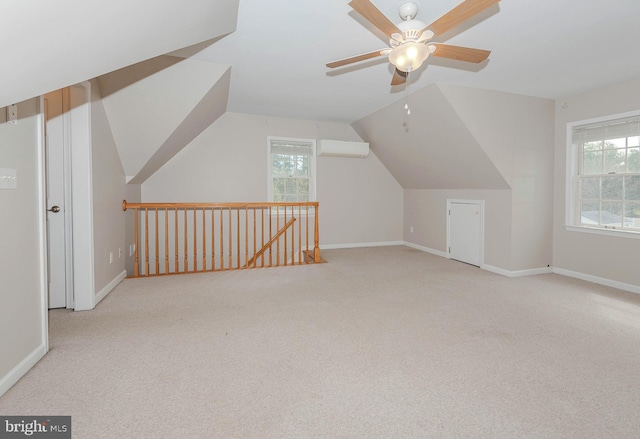 bonus room with plenty of natural light, a wall mounted AC, ceiling fan, and carpet flooring