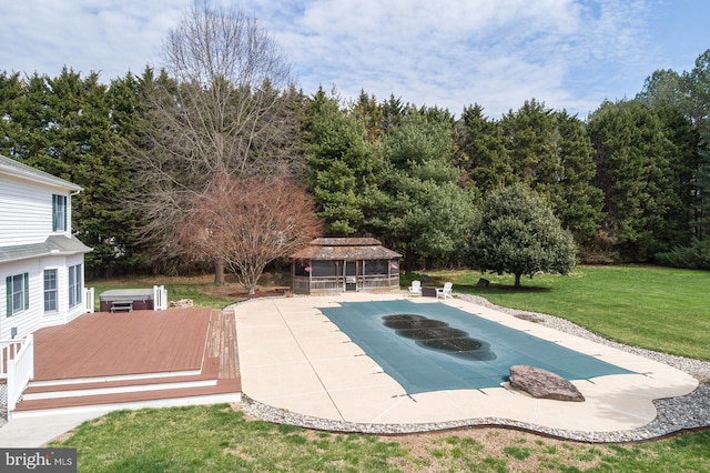 view of swimming pool with a patio area, an exterior structure, a covered pool, a wooden deck, and an outdoor structure