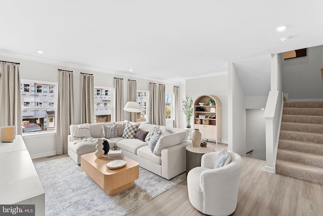living room featuring recessed lighting, stairs, light wood-style flooring, and crown molding