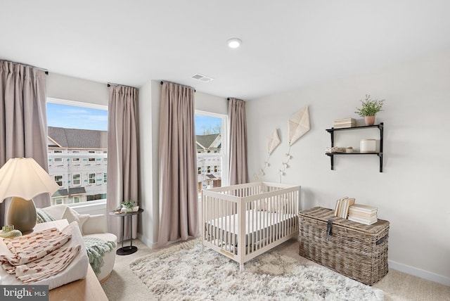 bedroom with visible vents, baseboards, and carpet