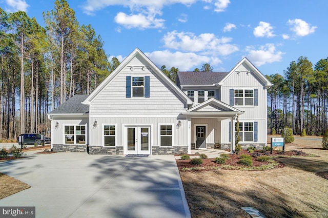 751 Bowie Shop Rd, Huntingtown, MD 20639 - view of front of property with french doors, board and batten siding, stone siding, and a shingled roof