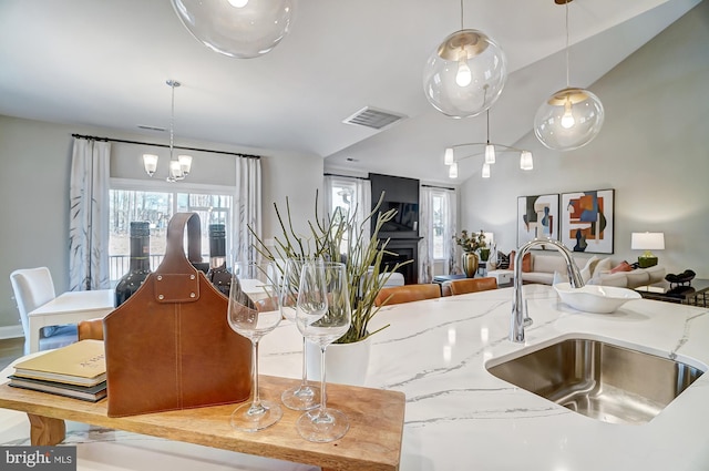 751 Bowie Shop Rd, Huntingtown, MD 20639 - kitchen with light stone countertops, visible vents, a sink, decorative light fixtures, and open floor plan