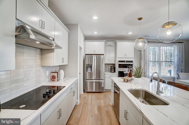 751 Bowie Shop Rd, Huntingtown, MD 20639 - kitchen featuring a sink, under cabinet range hood, pendant lighting, appliances with stainless steel finishes, and light wood-type flooring