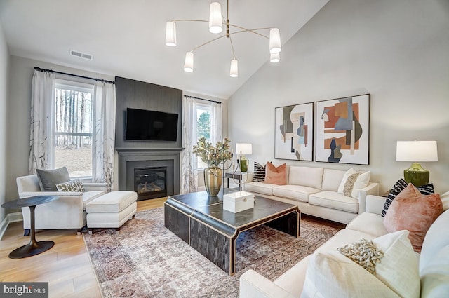 751 Bowie Shop Rd, Huntingtown, MD 20639 - living room featuring visible vents, high vaulted ceiling, a large fireplace, and wood finished floors