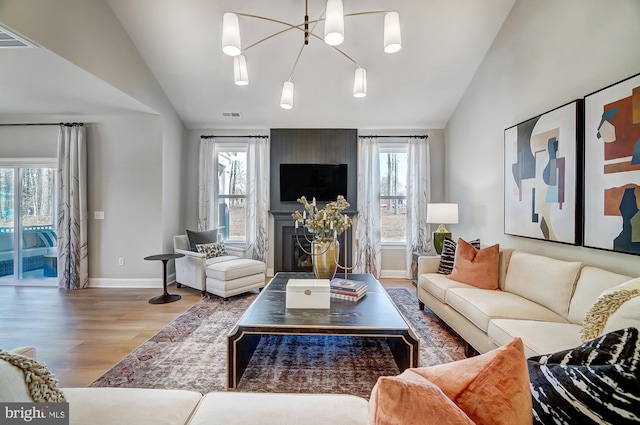 751 Bowie Shop Rd, Huntingtown, MD 20639 - living room with lofted ceiling, wood finished floors, visible vents, and a wealth of natural light
