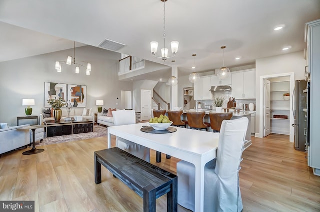 751 Bowie Shop Rd, Huntingtown, MD 20639 - dining area featuring visible vents, lofted ceiling, light wood-style flooring, recessed lighting, and stairs