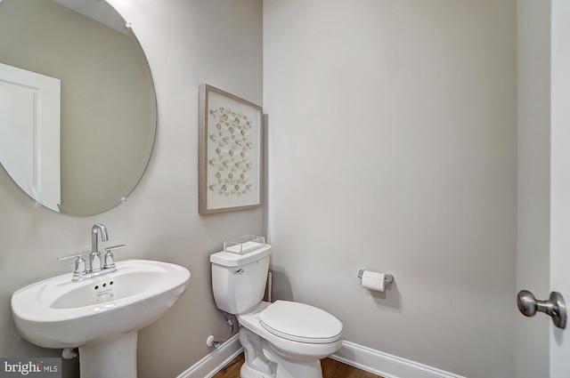 751 Bowie Shop Rd, Huntingtown, MD 20639 - half bathroom with a sink, baseboards, toilet, and wood finished floors